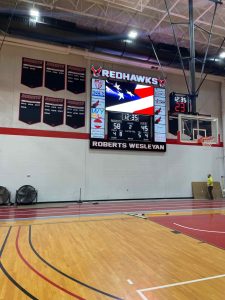 fiber install for new Roberts Wesleyean basketball court video scoreboard in Chili