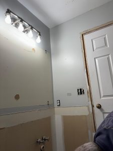 Outdated bathroom vanity lighting before electrical remodel in Penfield NY